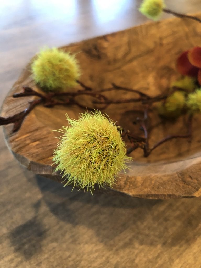 faux green puff ball from hobby lobby in hand carved wooden table centerpiece brown red green yellow