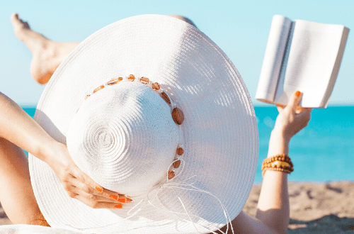 july teacher mental health reading a book on the beach relaxation calm self care for educator